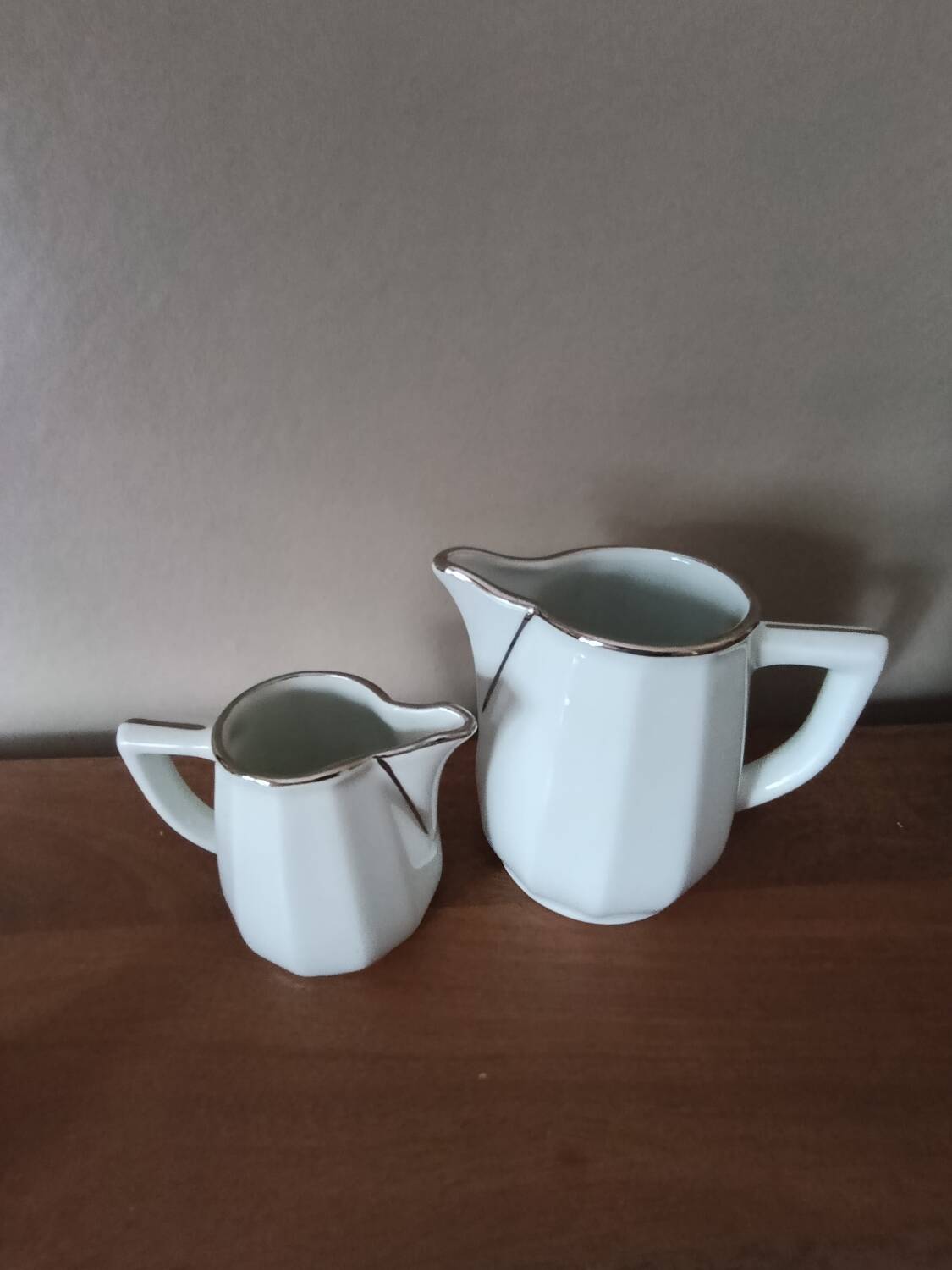 2 white porcelain milk jugs with platinum trim, Flora by Apilco.