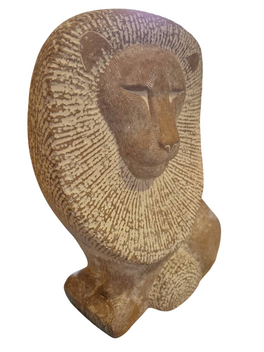 Sculpture of a lion in stone by Islay Grimes.