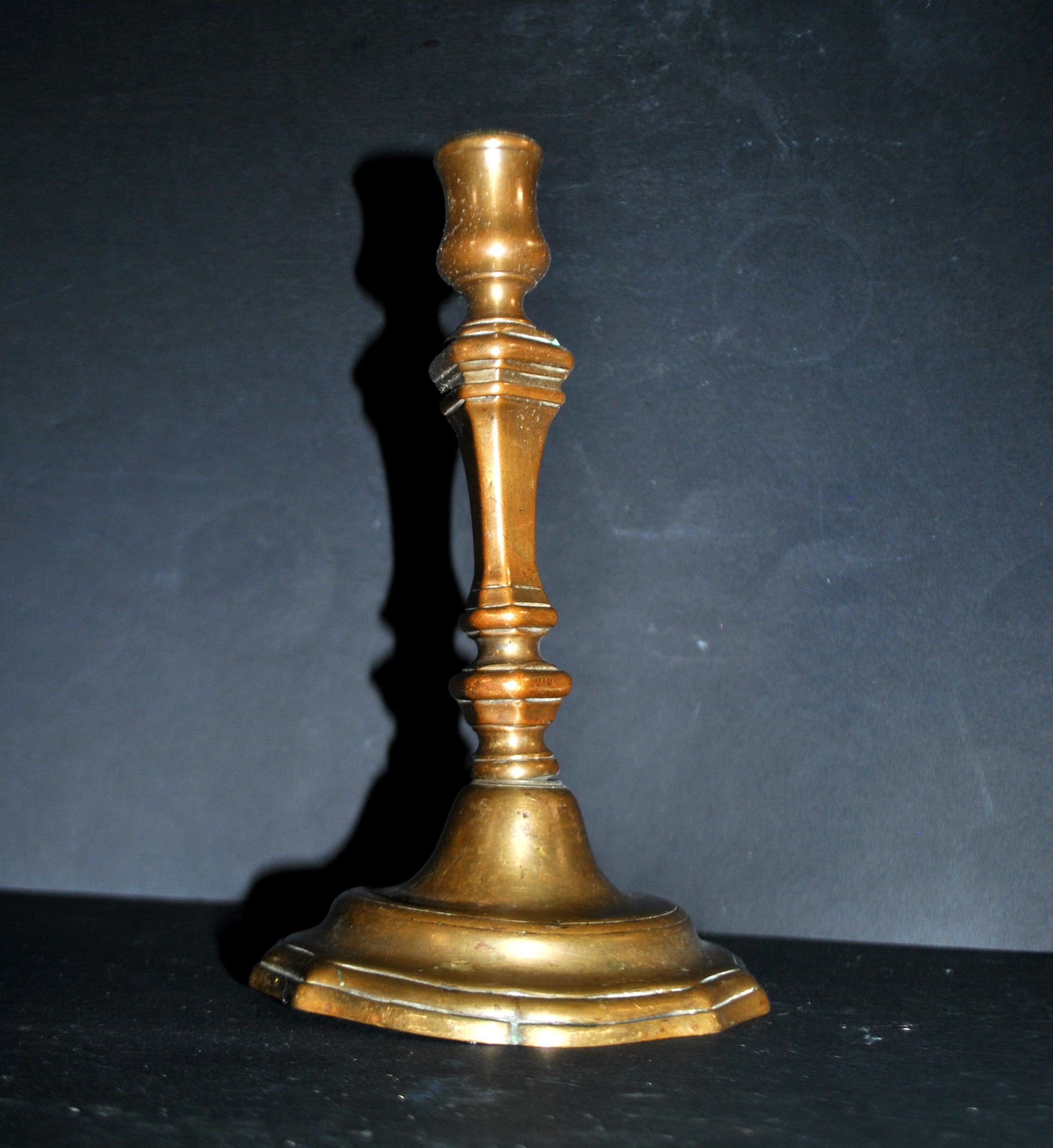 Antique candle holder, carved in bronze, 18th century.