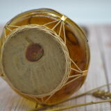 Amber decanter with wicker and golden chain