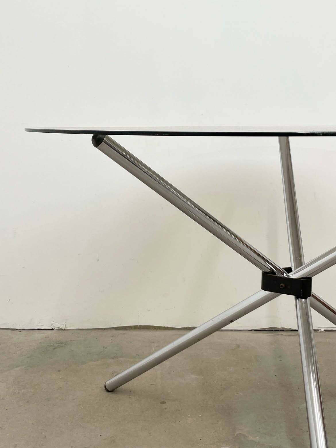 Round dining table in chrome and smoked glass.