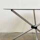 Round dining table in chrome and smoked glass.