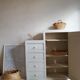 Old white asymmetrical chest of drawers