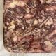 Pink marble trivet with brass ball feet.