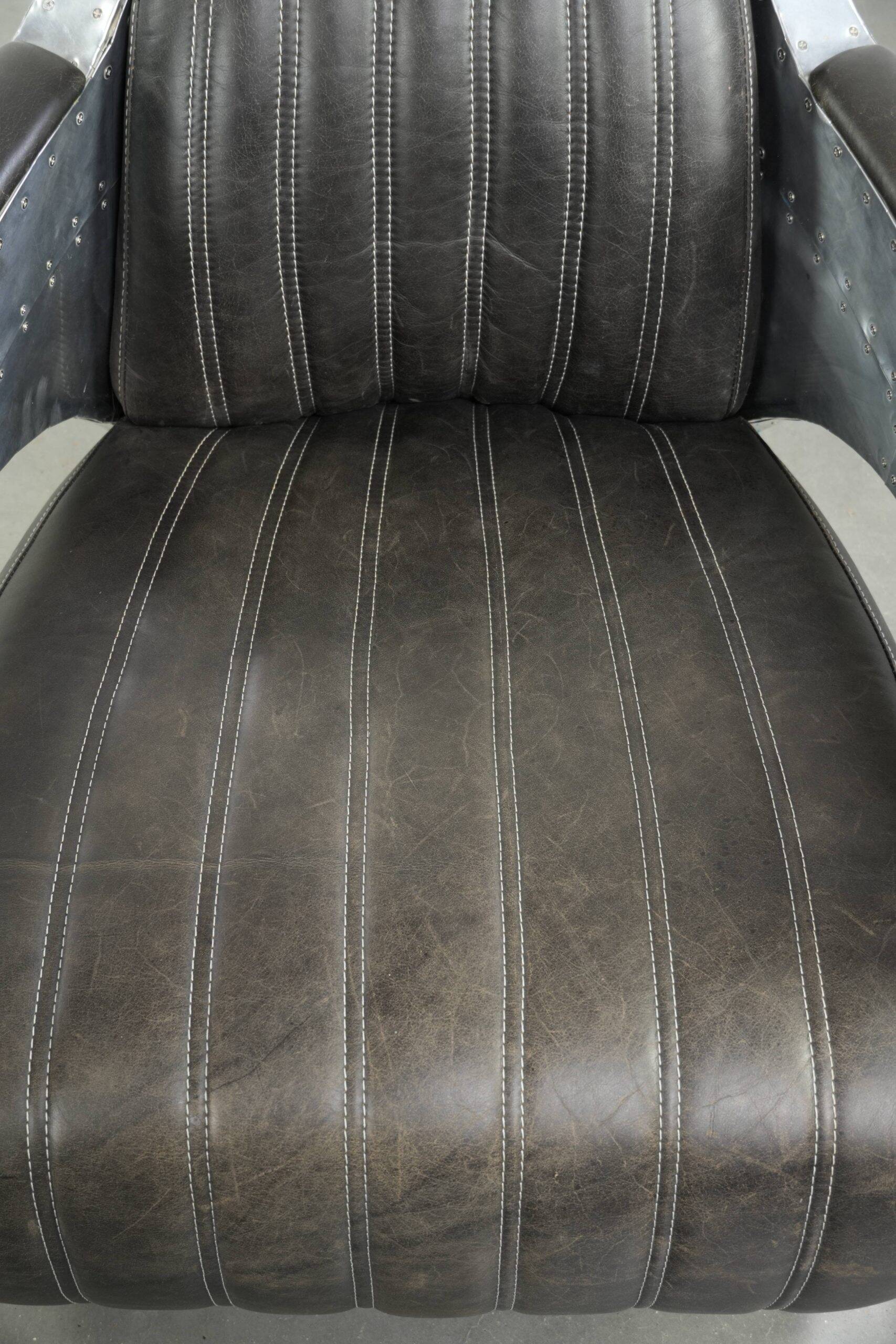 Cow leather aviator design armchair finished with aluminium and rivets