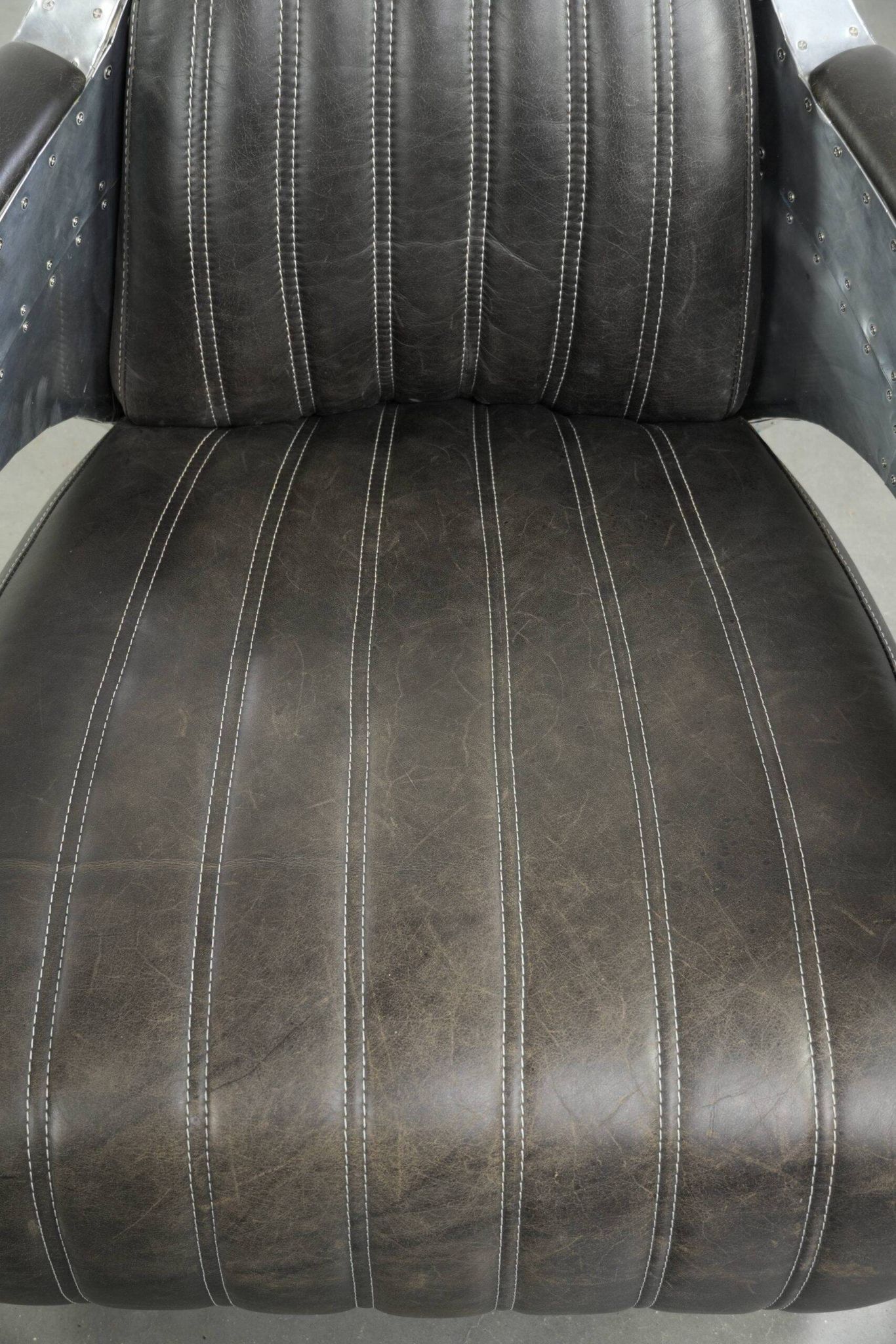 Cow leather aviator design armchair finished with aluminium and rivets