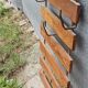 Wall-mounted coat rack in iron and wooden slats