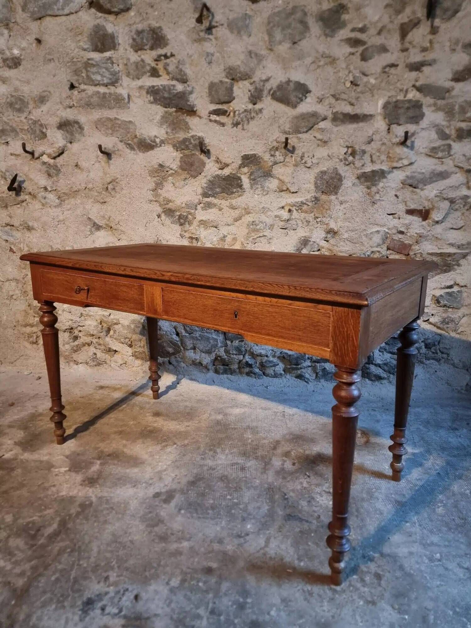 Antique French writing desk in oak with two drawers, 1920s.