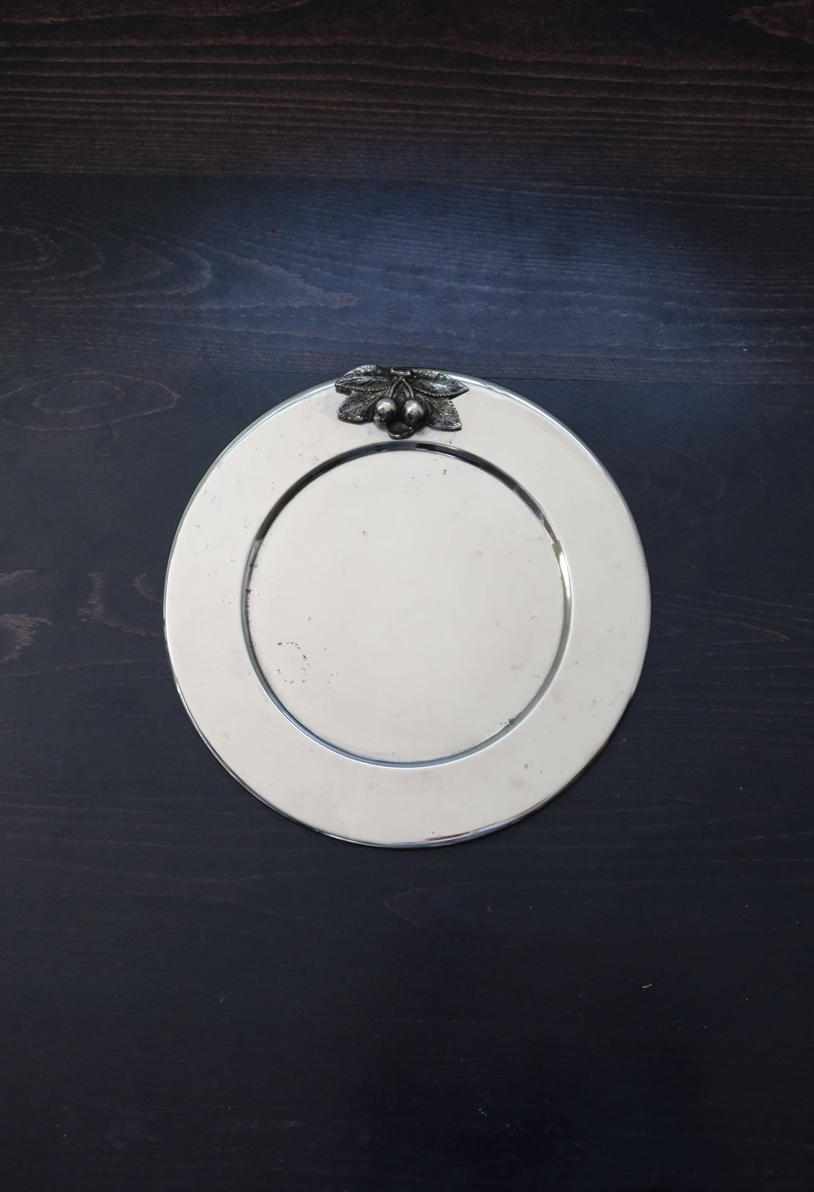 Vintage silver-plated round service tray with embossed cherries.