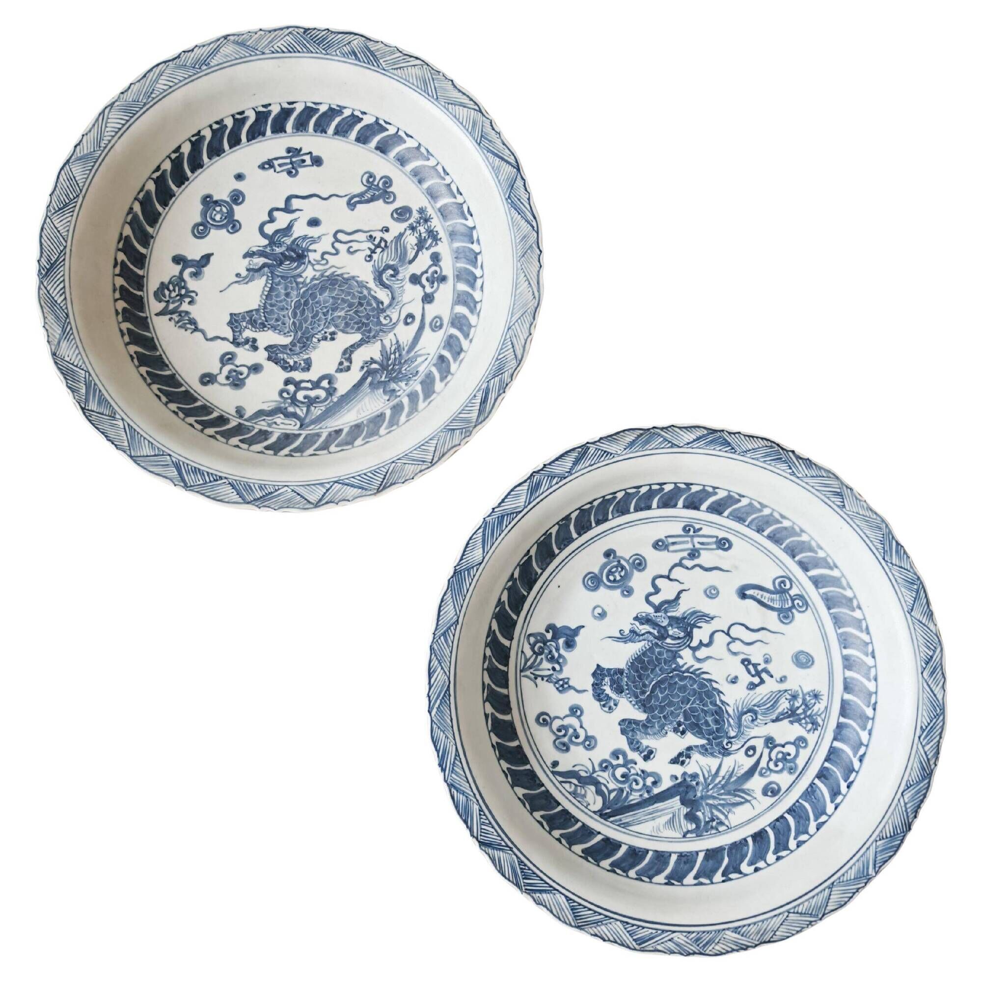 Pair of antique Chinese decorative plates with dragon motif.