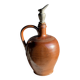 Ancient stoneware jug with a pewter spout.
