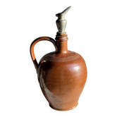 Ancient stoneware jug with a pewter spout.