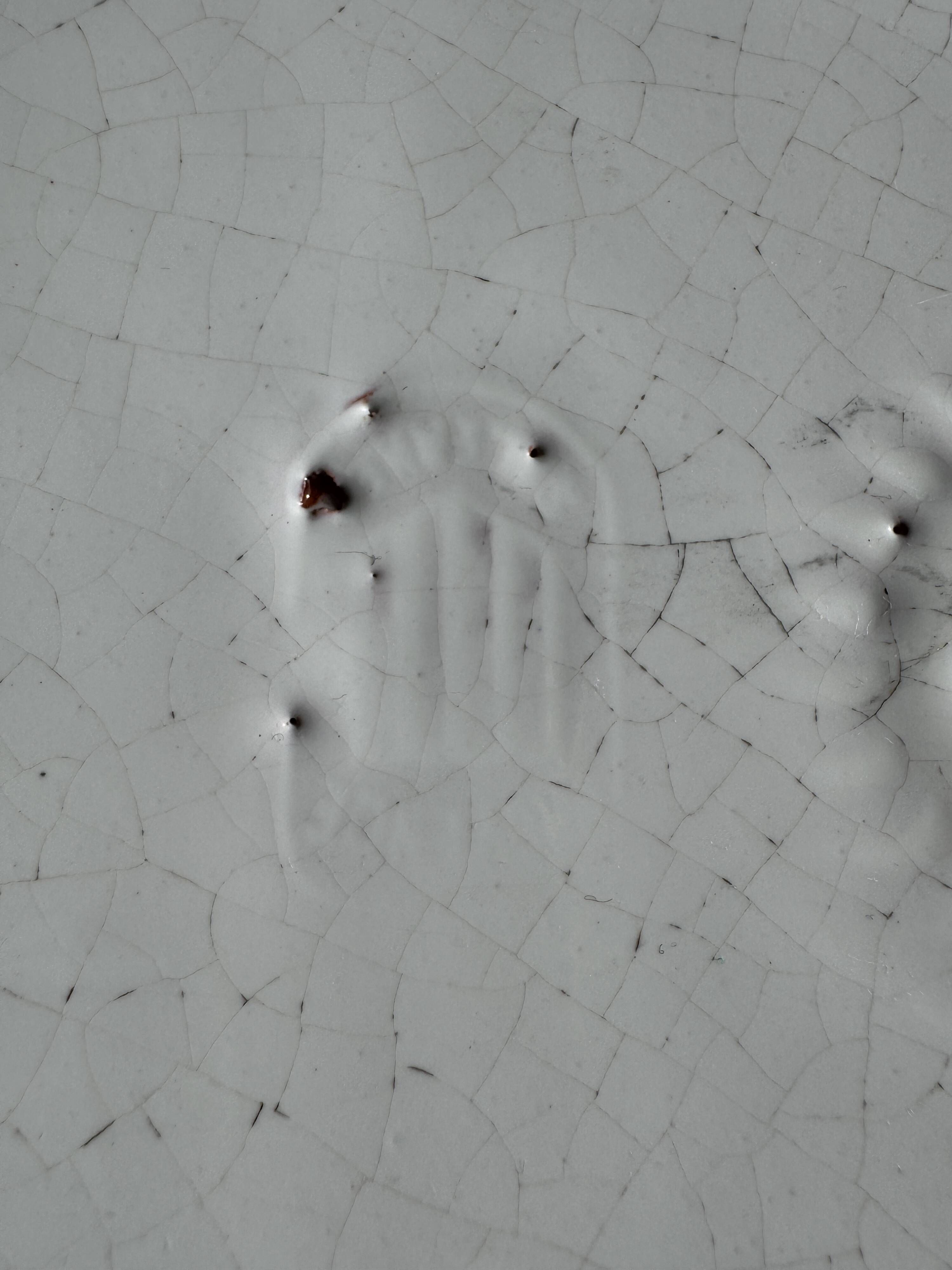 Antique oval-shaped white crackled faience plate with a scalloped edge.