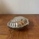 Antique silver-plated metal butter dish in the shape of a seashell