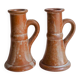 Set of two terracotta candle holders.