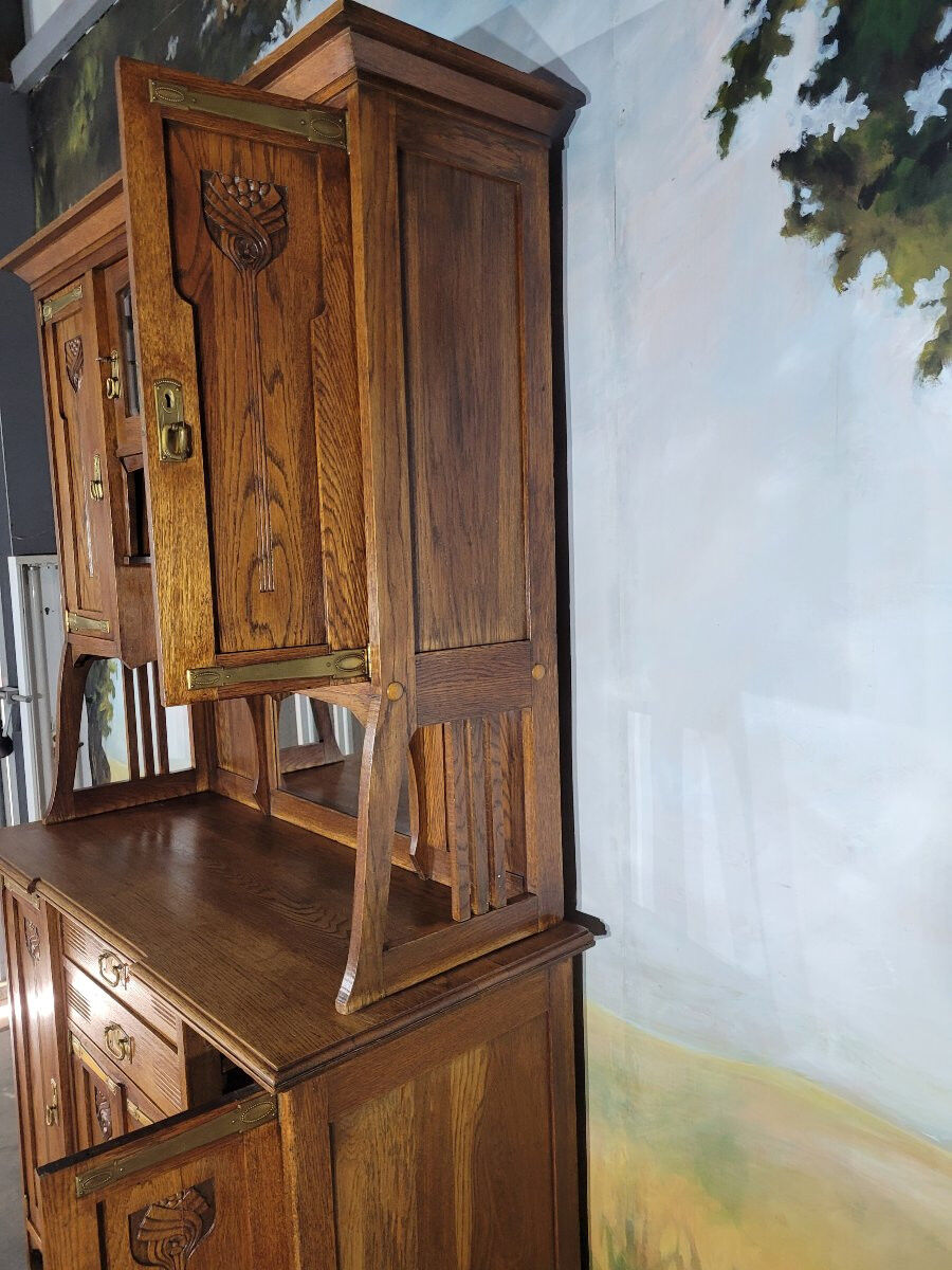 Glass-fronted oak sideboard from the Art Nouveau period.
