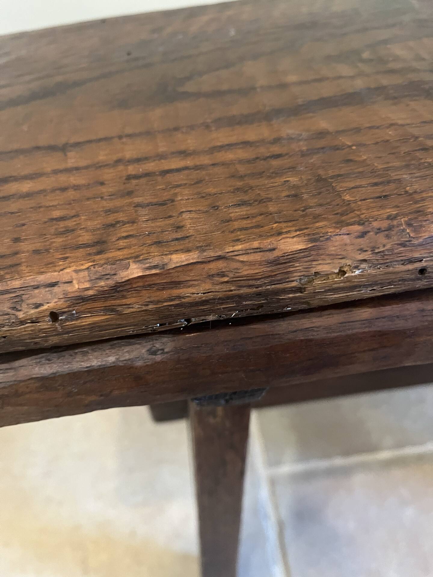 Small antique wooden bench with a folding backrest.