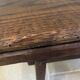 Small antique wooden bench with a folding backrest.