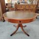 Round Regency dining table in mahogany and green leather with extensions - 20th century