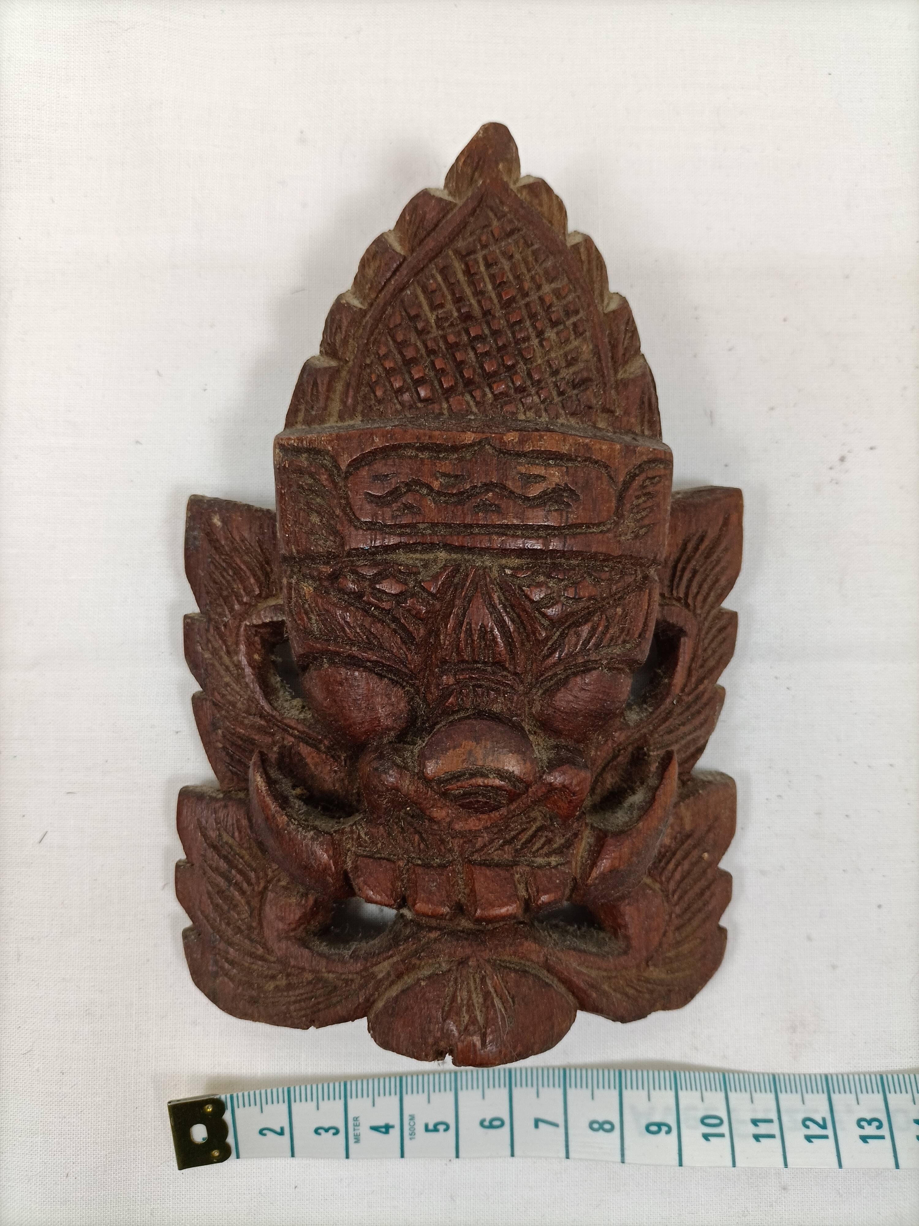 Asian decorative mask in carved wood