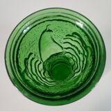 Green glass vase decorated with bunch of grapes and fruits