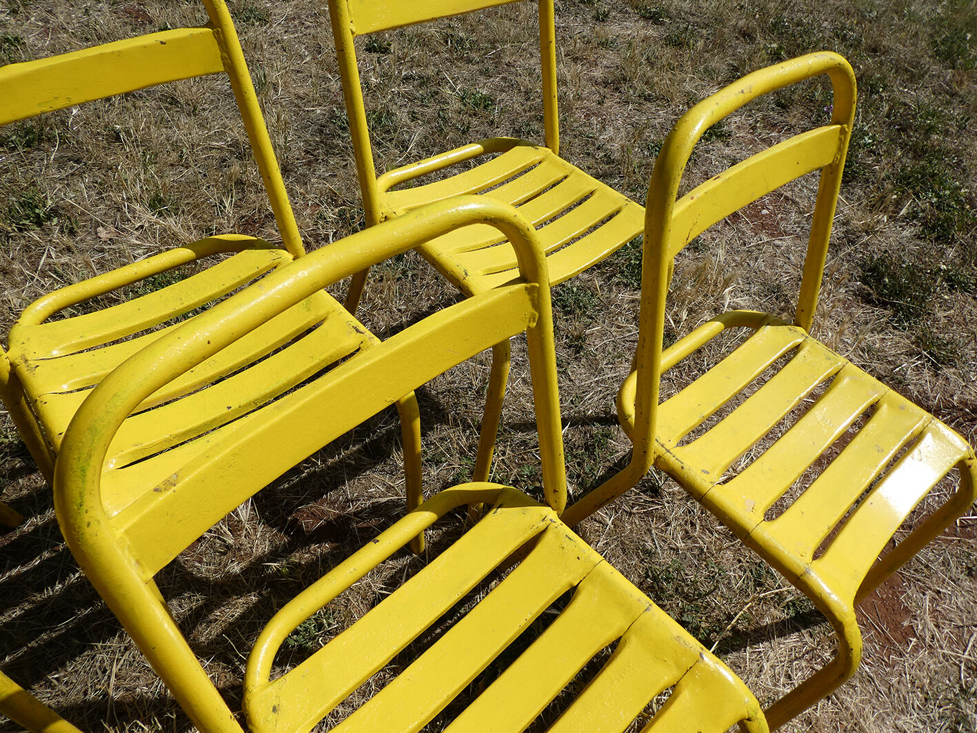 Lot of 11 yellow metallic bistro chairs from the 1950s