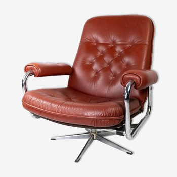 Armchair upholstered with red leather and frame of metal, of danish design from the 1960s