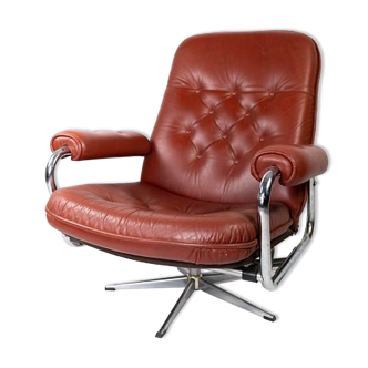 Armchair upholstered with red leather and frame of metal, of danish design from the 1960s