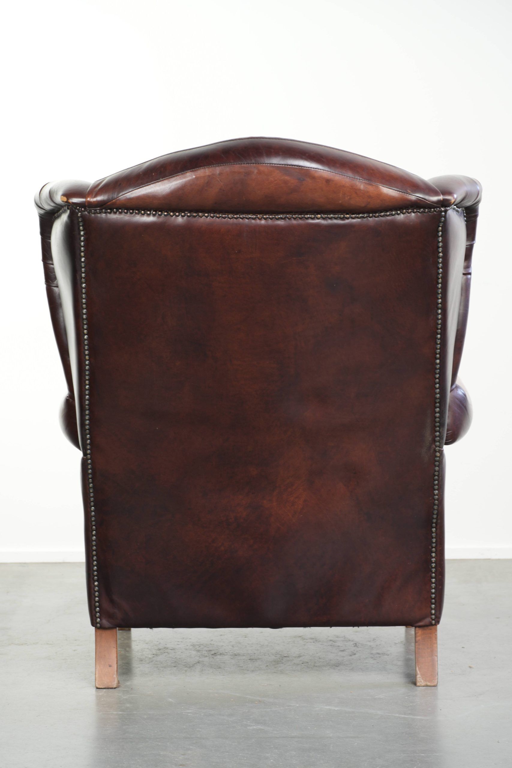 Comfortable cowhide wingback armchair in English style