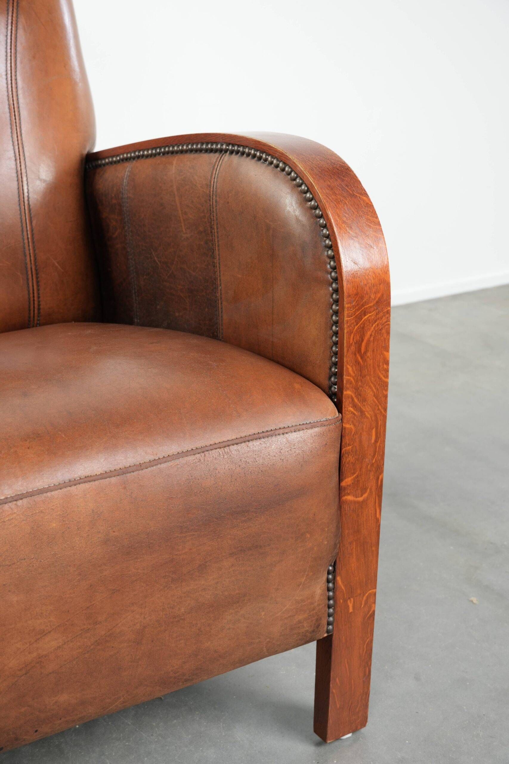 Sheepskin armchair in Art Deco style with wooden armrests