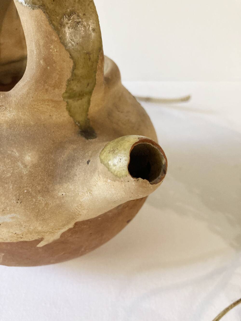 Small Provençal goat jug in creamy white and green enamelled stoneware