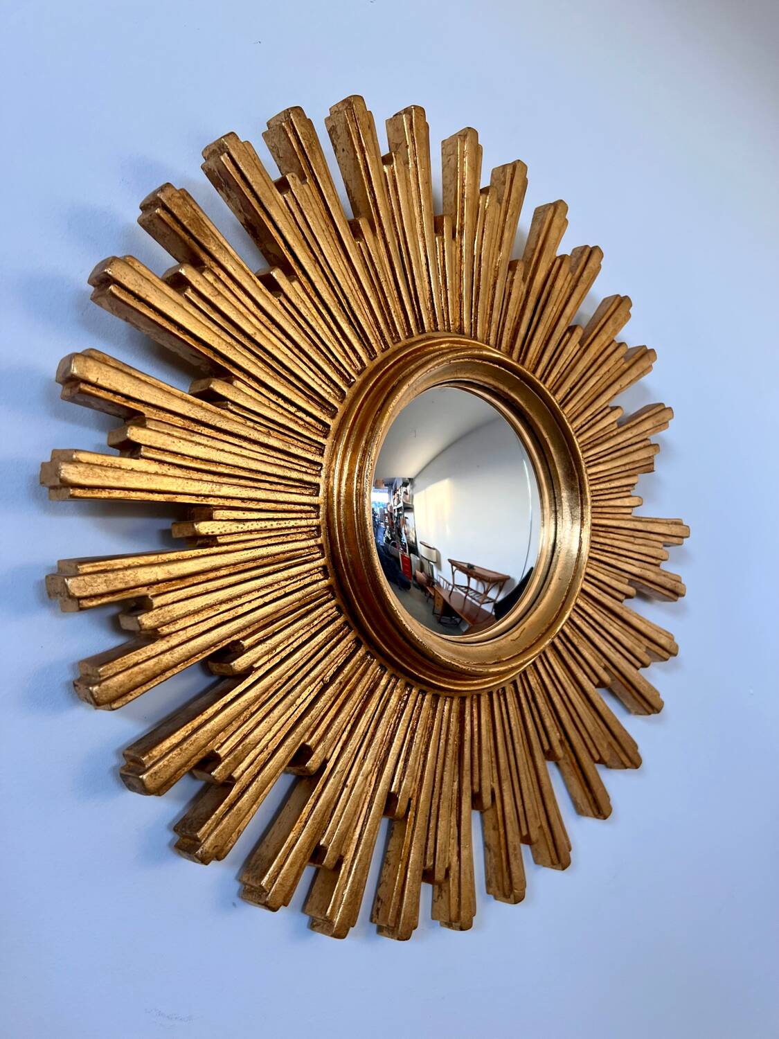 Old large golden sun mirror with rounded witch's eye in vintage resin from the 70s