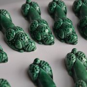 12 green earthenware knife rests