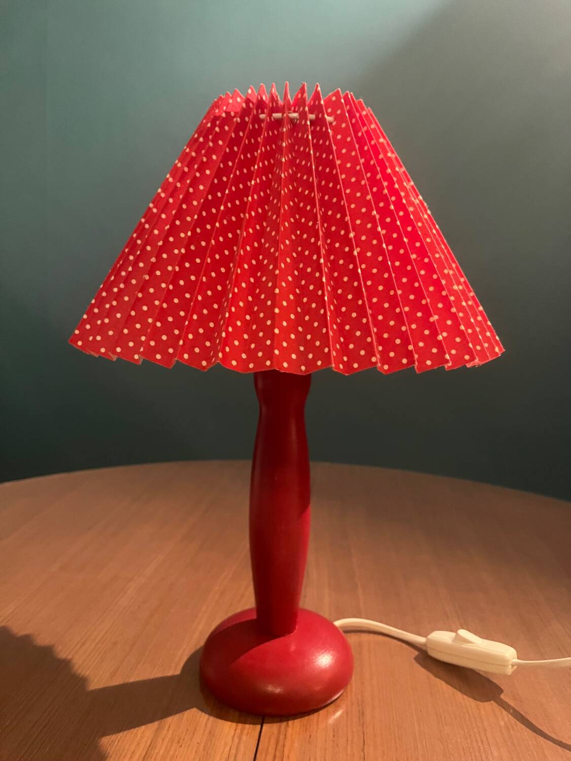 Wooden foot lamp with folded cardboard lampshade