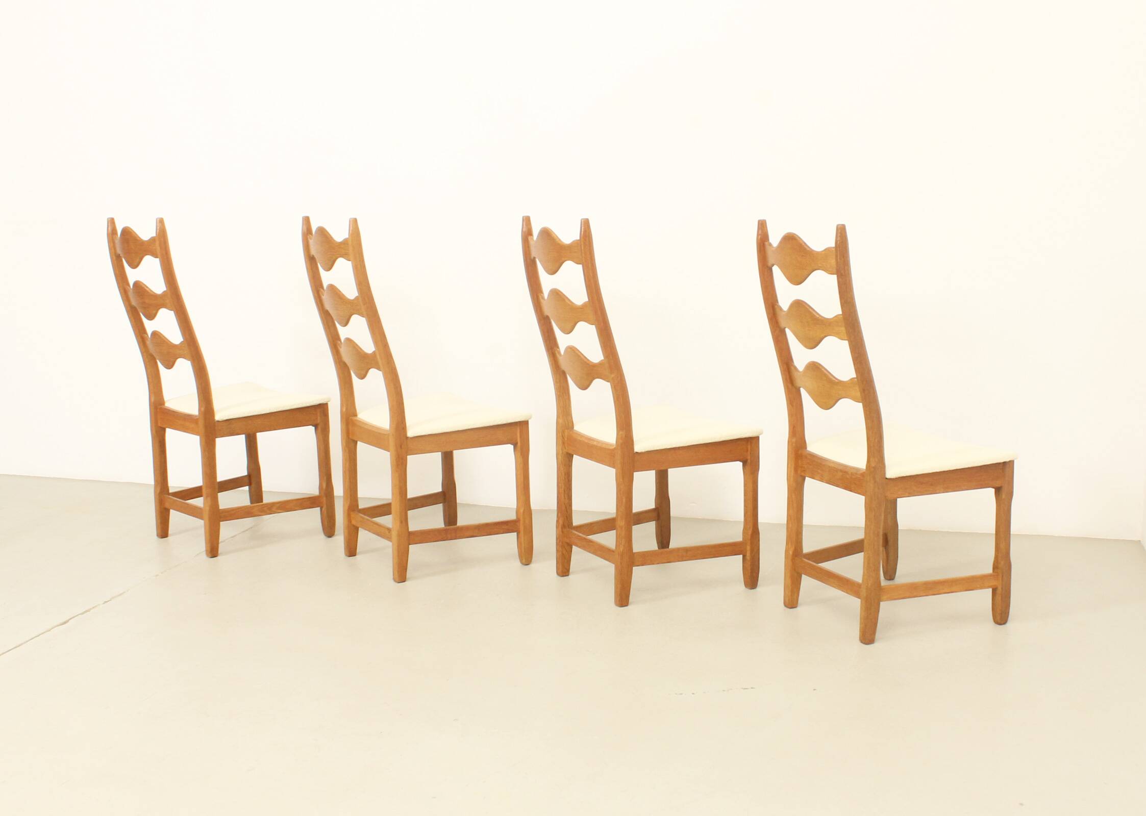 Four oak dining chairs by Henning Kjaernulf.