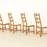 Four oak dining chairs by Henning Kjaernulf.