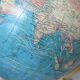 Luminous world map in tripod glass