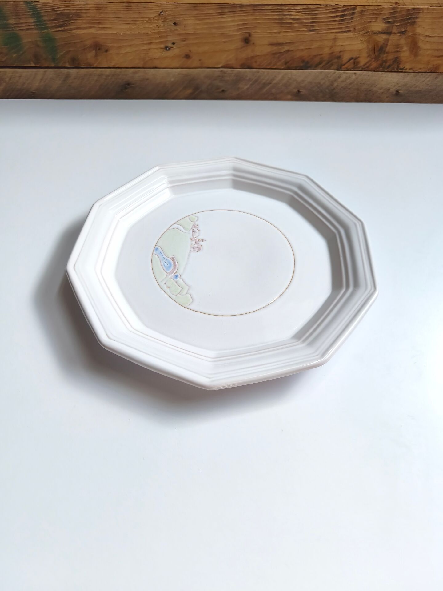 Round vintage Niderviller plate with a country decor.