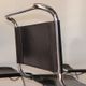 Series of 6 minimalist chairs in chrome metal and black leather around 1970
