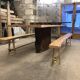 Chestnut and walnut solid table and benches with a central leg.