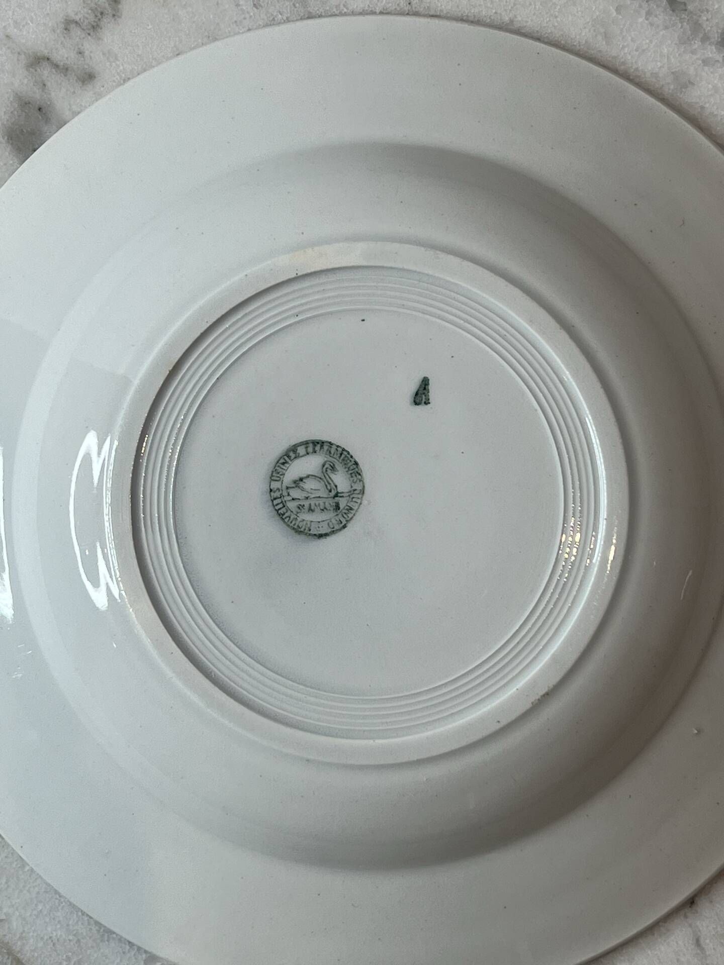 Set of 4 deep plates from Saint Amand with laurel wreath decoration.