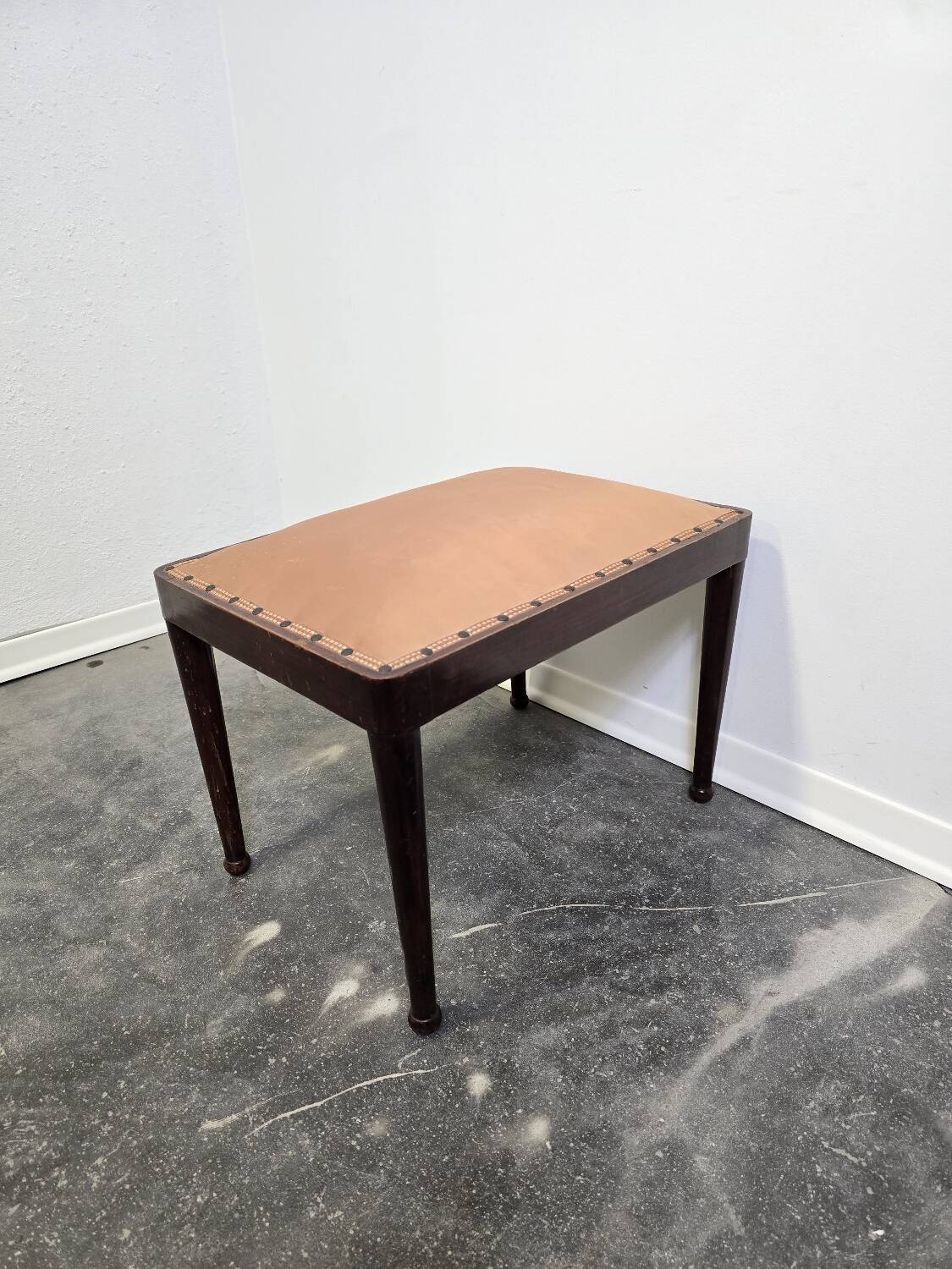 Vintage wooden ottoman from the 1940s with a silk top and studded trim.
