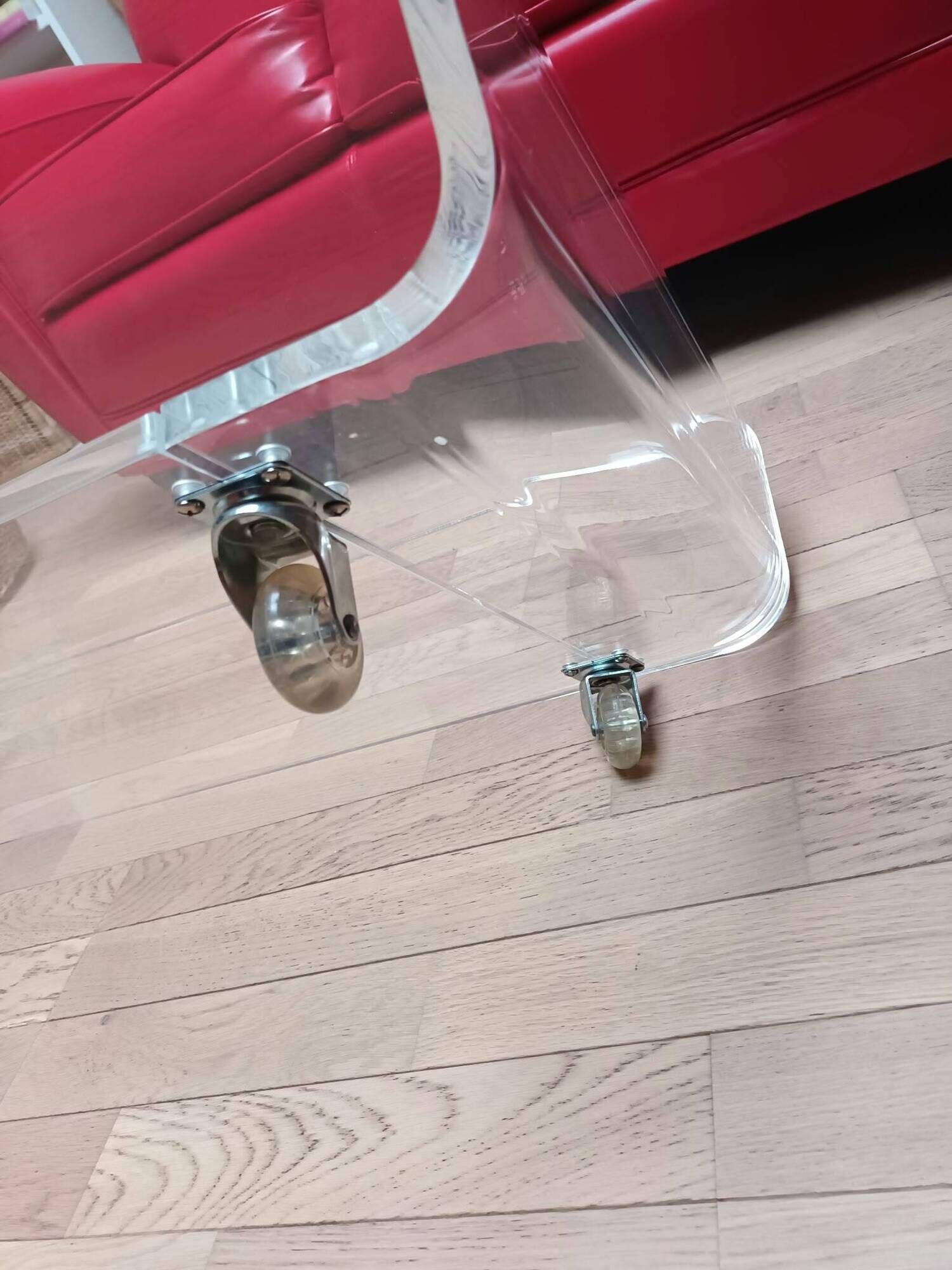 Design coffee table from Habitat in transparent plexiglass, mounted on wheels.