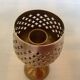 Lattice brass catchall and candlestick.