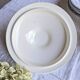 Antique mismatched earthenware soup plates with a tureen