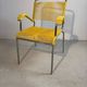 Yellow scoubidou armchair with a chrome tubular frame.