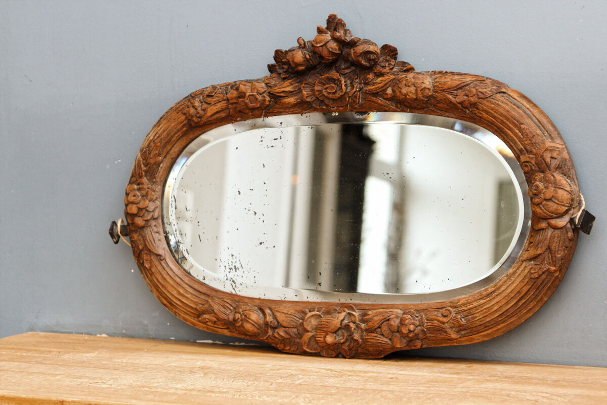 Beveled mirror in carved wood
