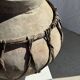 Very large light grey terracotta pot with handles and rattan crossbars.