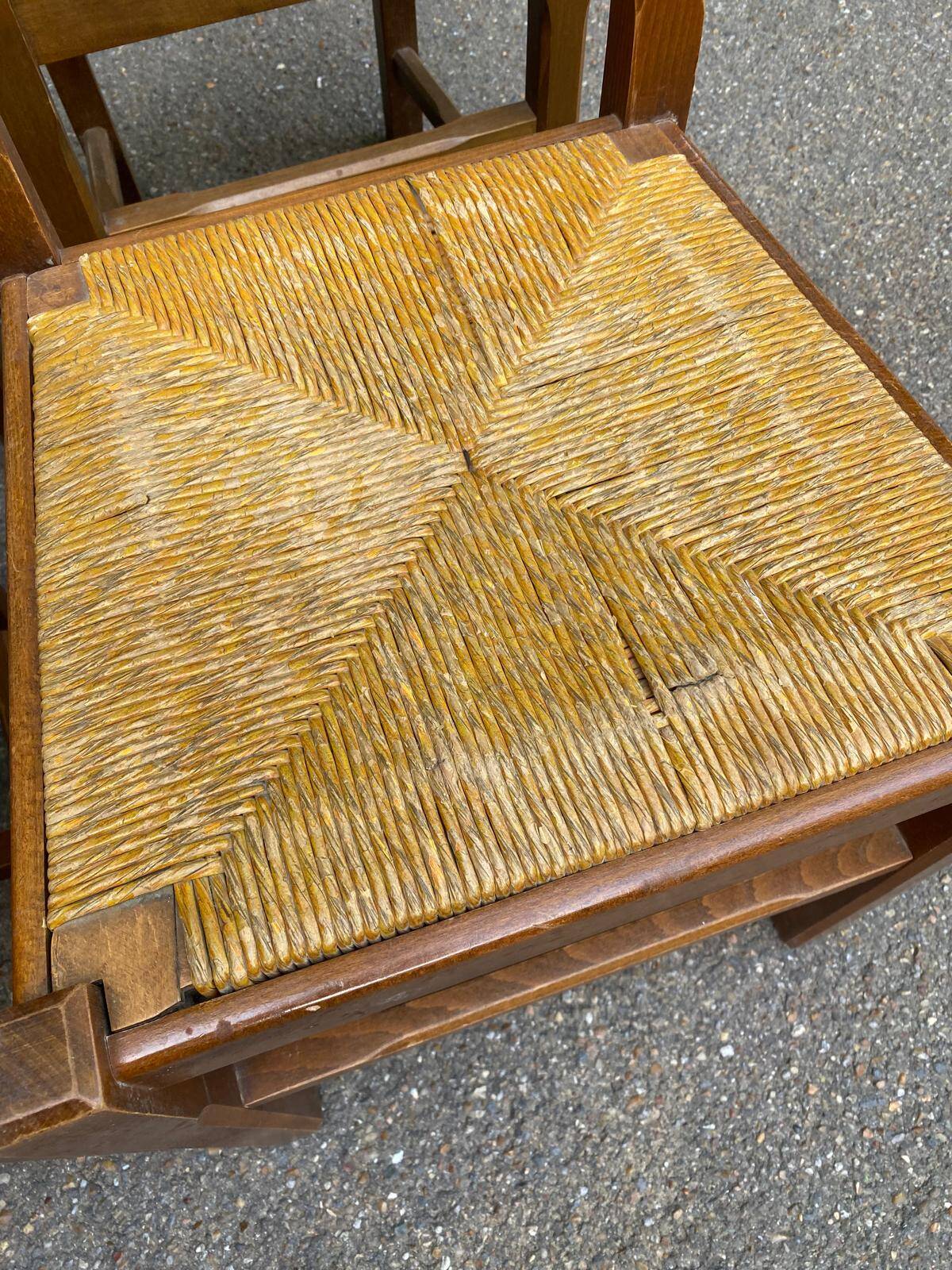 6 light solid wood chairs with high straw backs, farmhouse style.