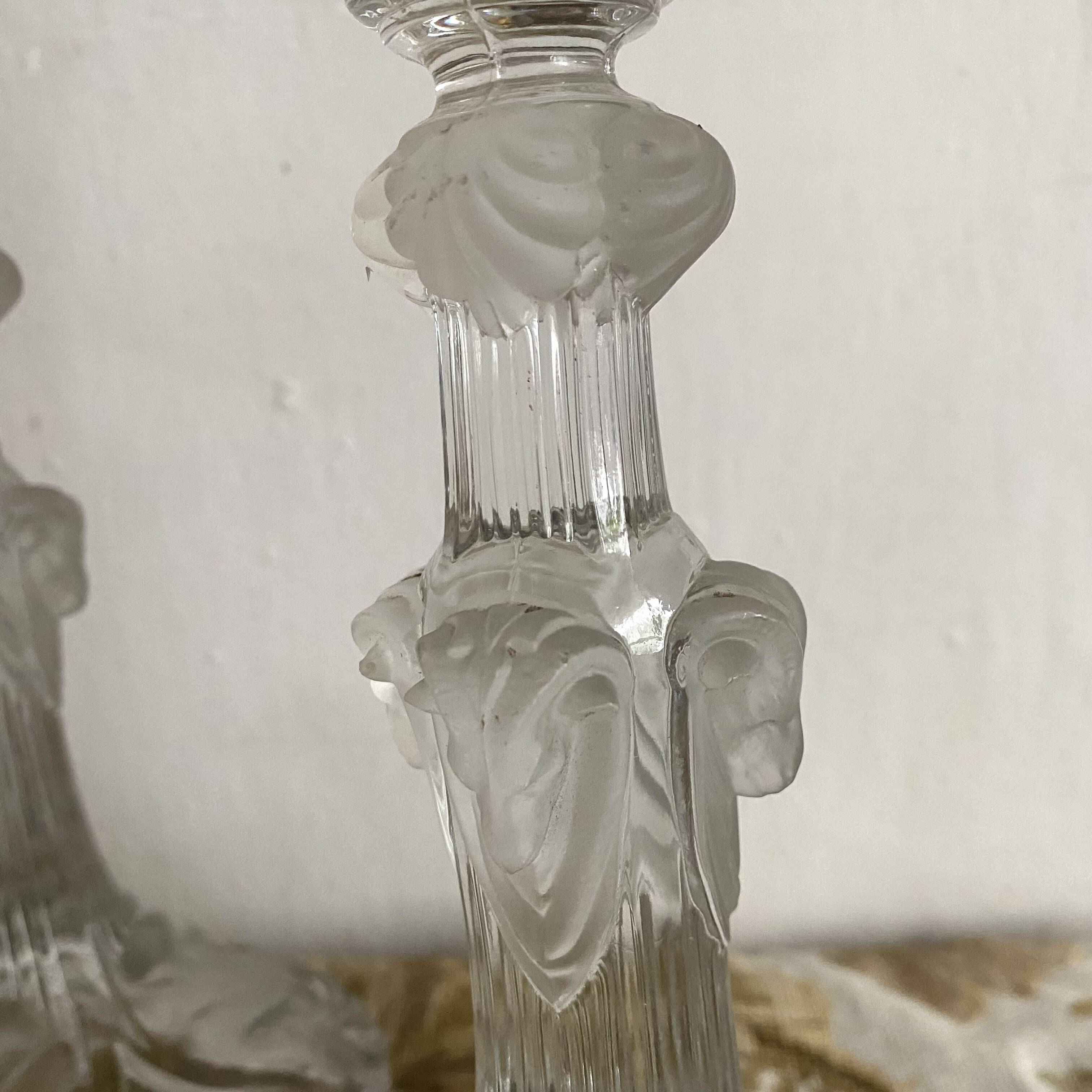 Pair of moulded glass candlesticks, ram heads and masks